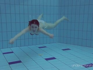 White swimsuit with tattoos – deity Roxalana Cheh underwater